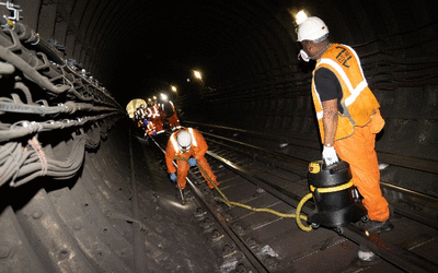 cleaning team using vacuums to clean tunnel walls and floor